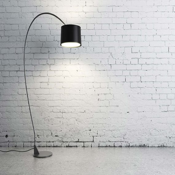 turned on black torchiere lamp